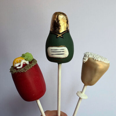 New Year themed cake pops including a bottle of champagne, champagne glass, and bloody mary